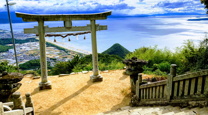 torii gate withe ocean and mountain